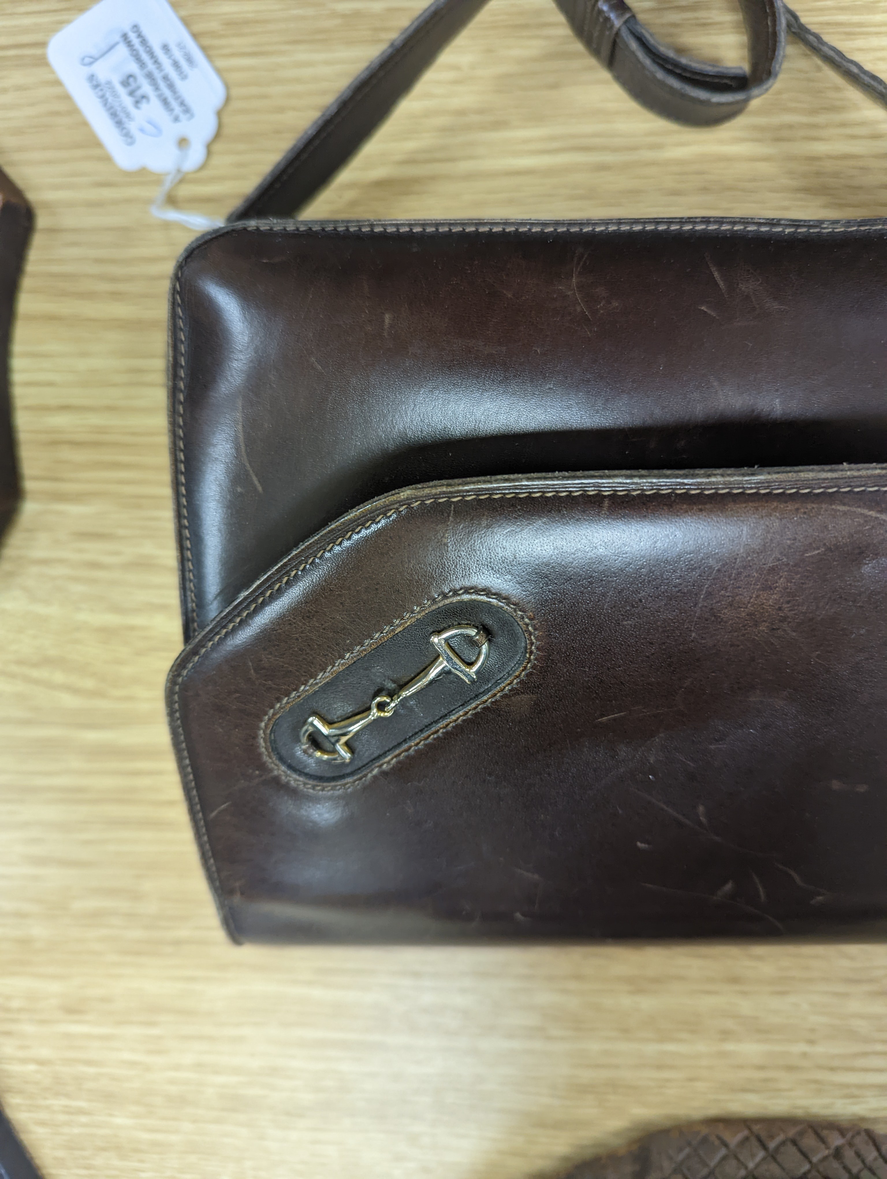 A vintage brown leather handbag stamped 